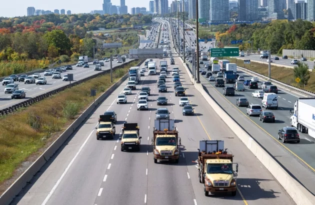 Arial view of trucks from the Miller Group driving down a busy section of Highway 401