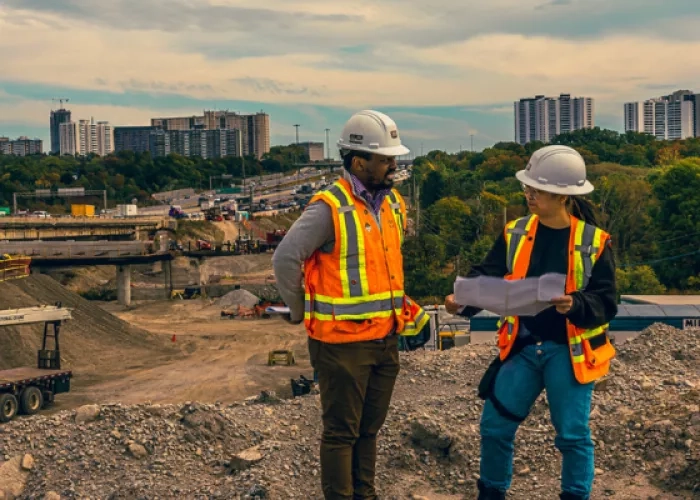 Two engineers discussing documents on a job site