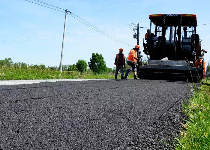Colas crews pave the surface of a recently rehabilitated road. 