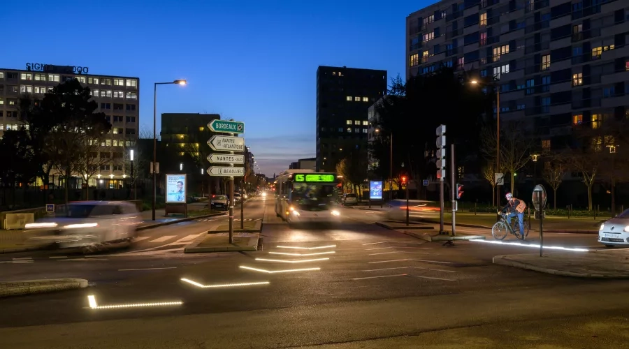 Colas’ Flowell technology lights up a roadway in France with arrows to alter drivers a bus about to turn. 