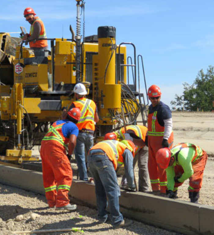 Standard General Calgary crew performs installation of curbs as part of a road construction project. 