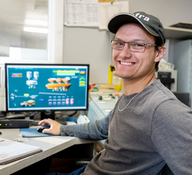 Colas Quebec employee showing engineering designs on a computer screen