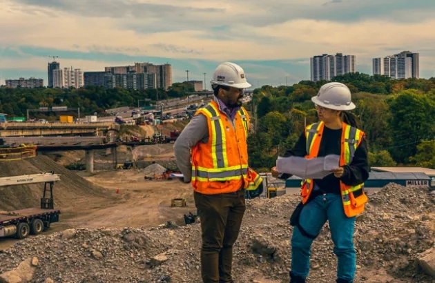 Two engineers discussing documents on a job site