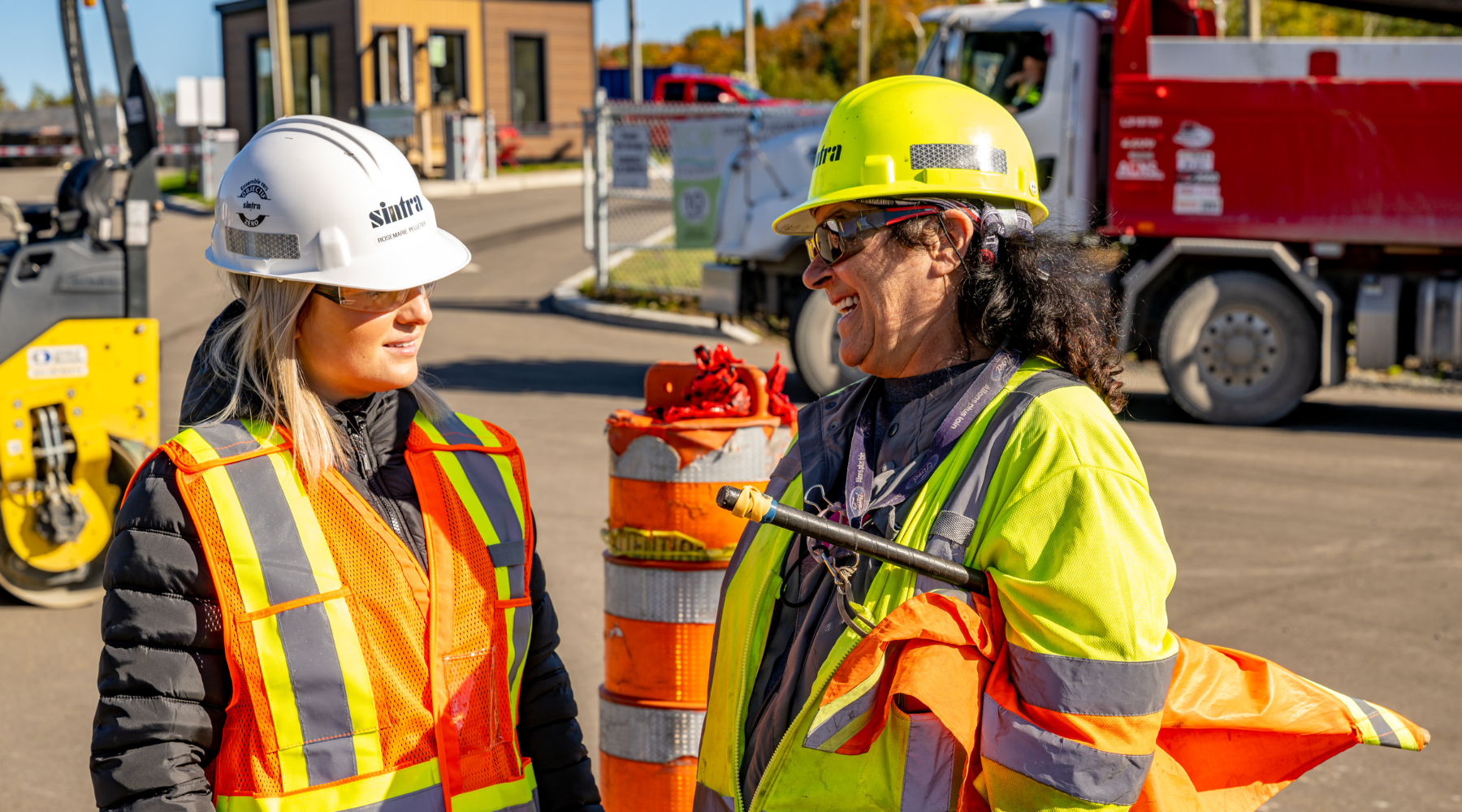 Two female Colas team members having a conversation on a construction site. 