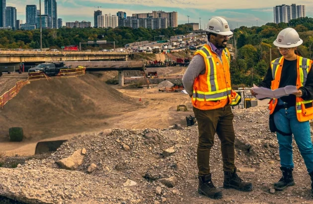 Arial view showing an engineer and a trainee from The Miller Group reviewing documents on the construction site for the 401 Rehabilitation