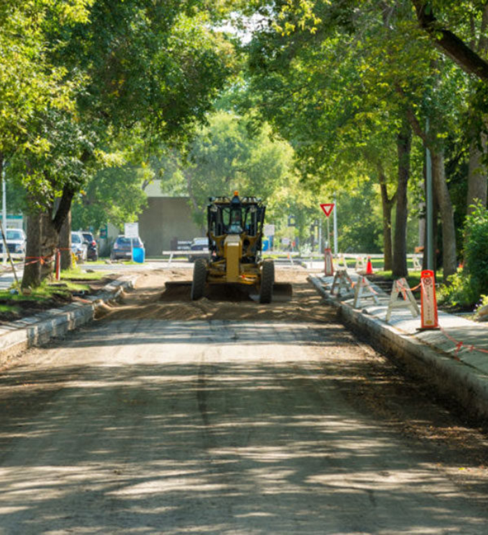 Standard General Edmonton crews perform paving work on a residential street.