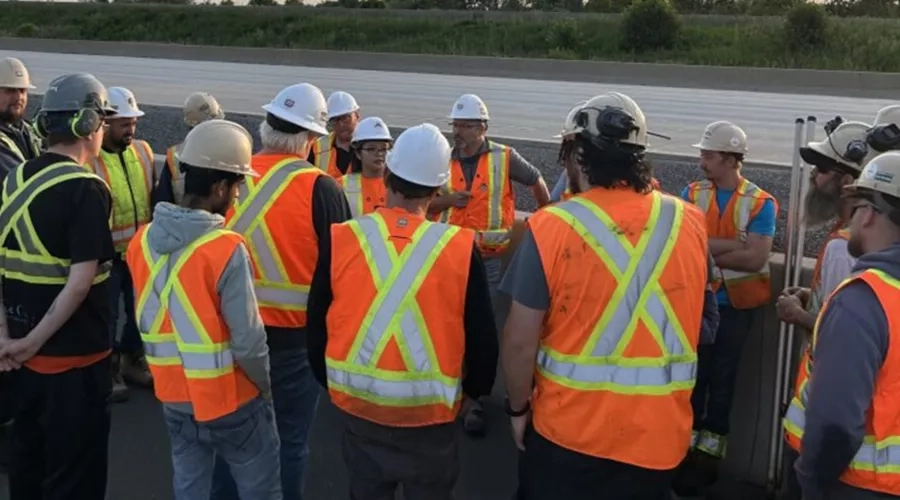 Miller Group employees working on the Highway 401 rehabilitation project meet for morning safety talk.