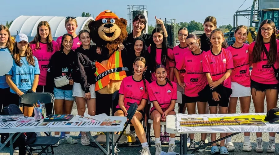 Colas Quebec employees and their families pose for a photo during a community event.