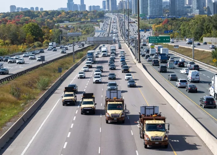 Arial view of trucks from the Miller Group driving down a busy section of Highway 401
