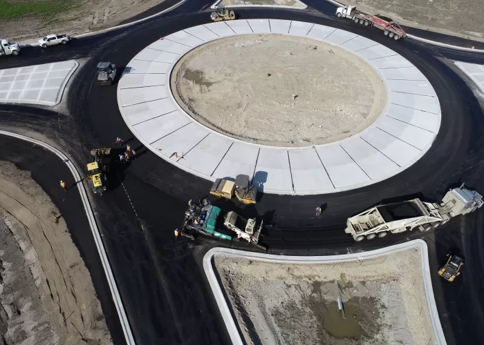 Arial view of teams at N.P.A. paving a roundabout on Highway 40