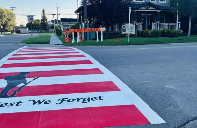 Photo of the competed Veteran's crosswalk, featuring the silhouette of a soldier and phrase "Lest We Forget"