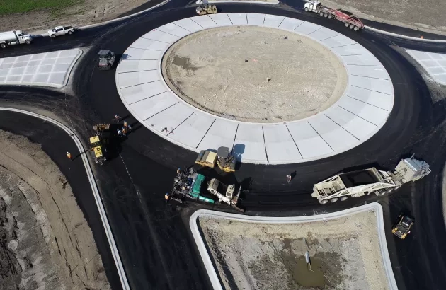 Arial view of teams at N.P.A. paving a roundabout on Highway 40