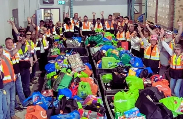 N.P.A. team at the Wood Buffalo Food Bank Association with collected food boxes. 