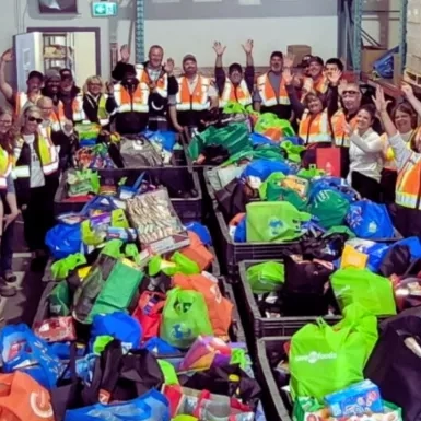 N.P.A. team at the Wood Buffalo Food Bank Association with collected food boxes. 